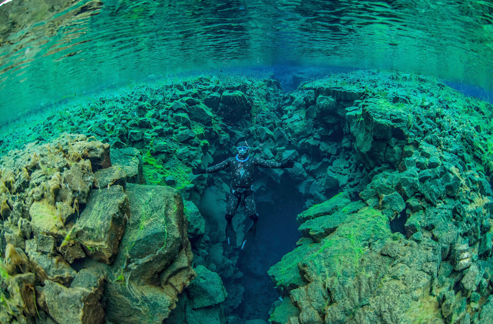 Freediver ascending in Silfra little crack