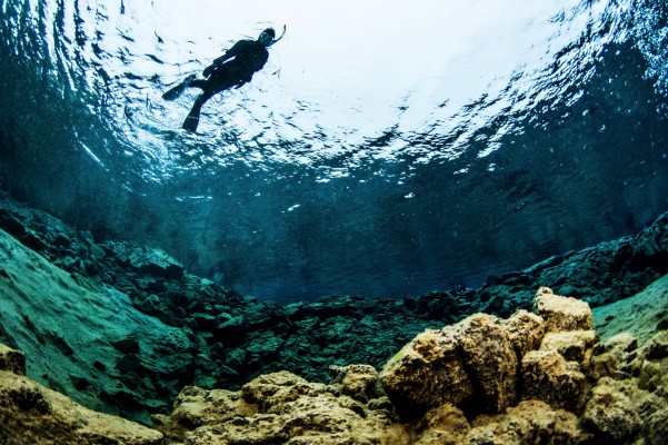 snorkeler from below in silfra fissure