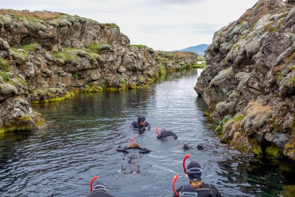 Guide taking photos of snorkelers on the DIVE.IS snorkeling tour in Silfra fissure